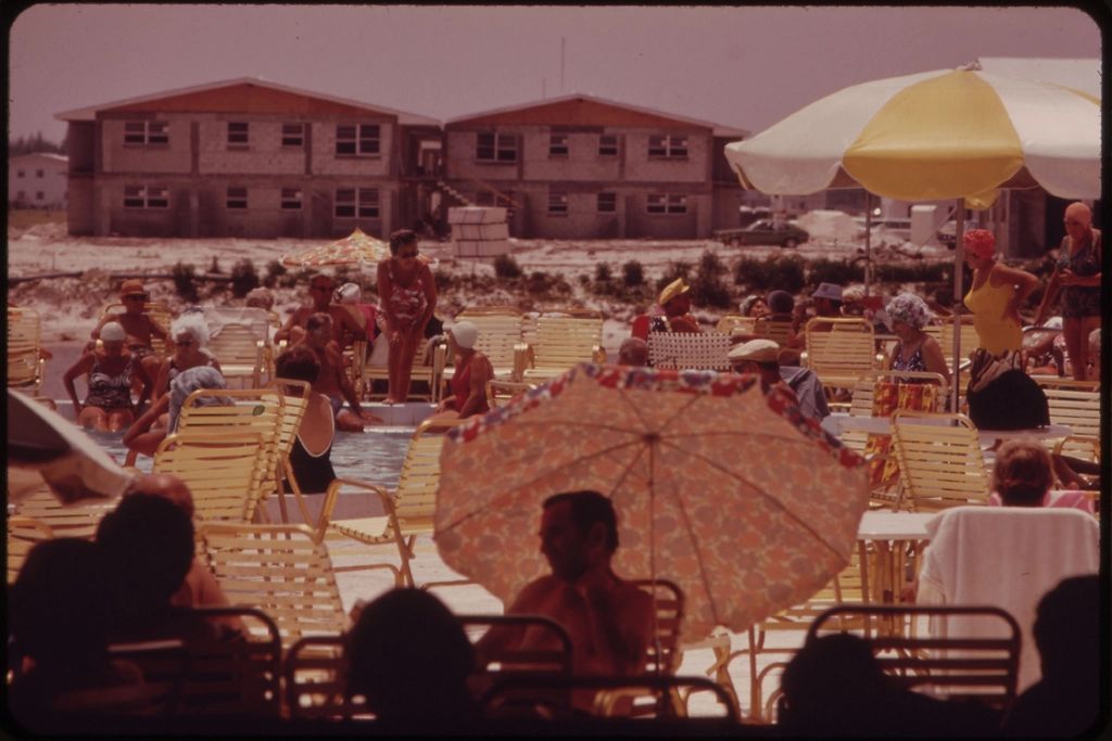 Sun loungers and a parasol beside the pool